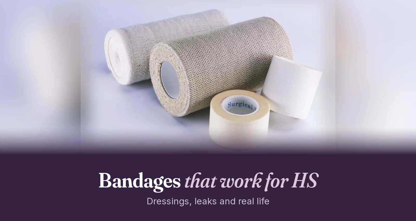 Rolls of elastic bandage and gauze next to a roll of surgical tape on a plain light surface