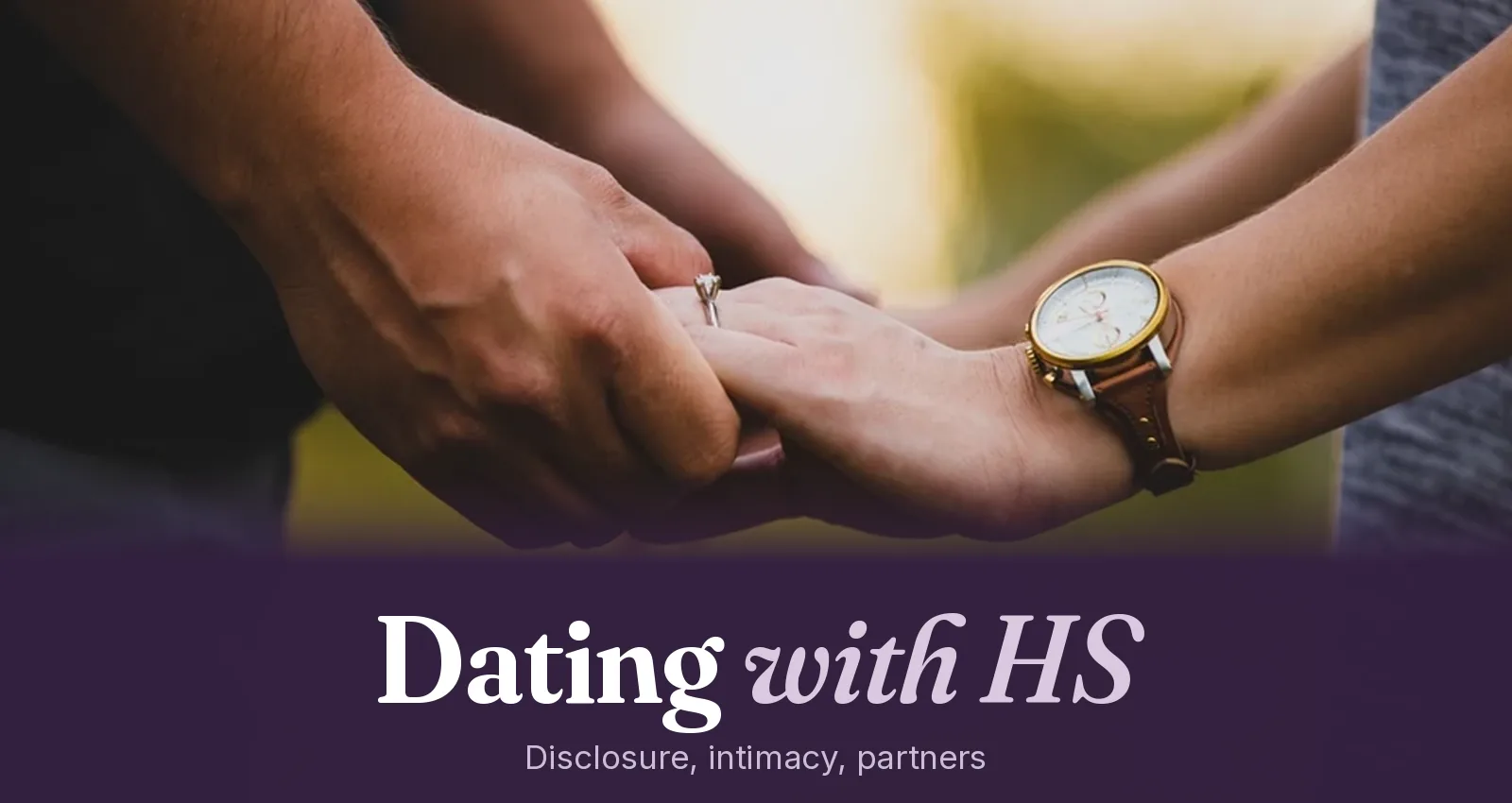 Two people holding hands outdoors in warm evening light